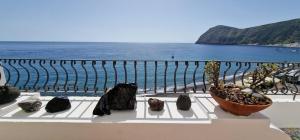 a group of rocks sitting on a ledge near the ocean at Case vacanza Eolie in Canneto