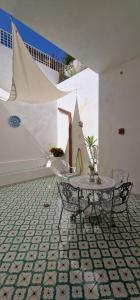 a room with a table and chairs and a staircase at Case vacanza Eolie in Canneto +41 photos