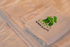 a close up of a white towel on a bed at Suoi Da Homestay in Ga Lăng Cô +61 photos