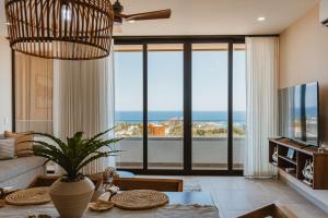 a living room with a view of the ocean at Torre San Angel Infinity Pool Arch Sunset Views in Cabo San Lucas