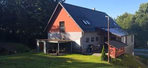 a large house with an orange and white at Apartmány Tamnakonci in Deštné v Orlických horách