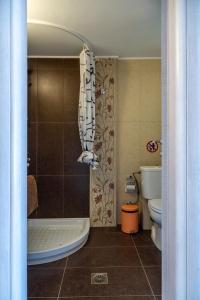 a bathroom with a tub and a toilet and a shower at Eagles Nest Panoramic SeaView Apartment in Thérissos +18 photos