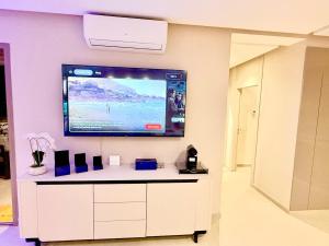 a flat screen tv on the wall of a room at Luxury Apartment with Pool & Parking in Tamraght 10 mn from Taghazout in Tamraght Ouzdar