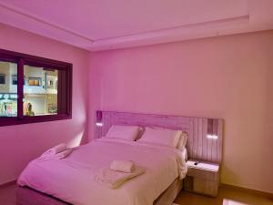 a bedroom with a bed with two towels on it at Luxury Apartment with Pool & Parking in Tamraght 10 mn from Taghazout in Tamraght Ouzdar