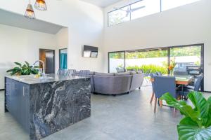 a living room with a couch and a table at Uvita-great Location-3 Bedroom-private Pool-gated in Uvita