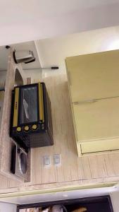 a tv sitting on a counter in a room at living Hotel in 6th Of October