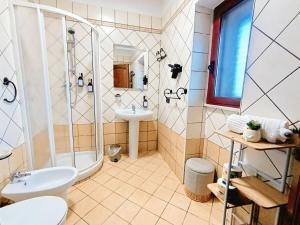 a bathroom with a shower toilet and a sink at Polizzihouse in Polizzi Generosa
