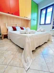 a large bed in a room with colorful walls at Polizzihouse in Polizzi Generosa