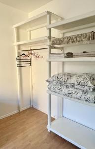 a room with white shelves with pillows on them at Mo&Ko Kalamaja Apart - Self Check-in in Tallinn