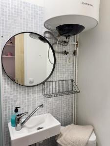 a bathroom with a sink and a mirror at Mo&Ko Kalamaja Apart - Self Check-in in Tallinn +7 photos