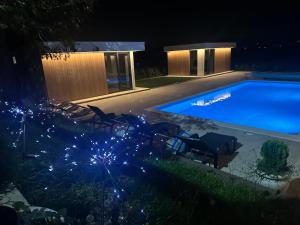 a swimming pool at night with christmas lights at Elysium1 in Banja Luka +4 photos