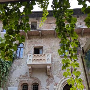an old building with a balcony on the side of it at EJ Station Corner in Verona