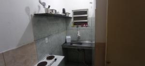 a small bathroom with a sink and a sink at Residencial Barbosa - Apto 101 in Macaé