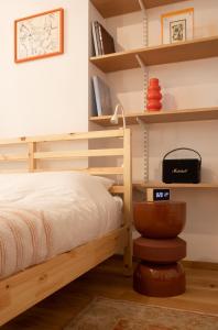 a bedroom with a wooden bunk bed and shelves at Cosy Studio on Wagner street, Riga Old Town in Rīga