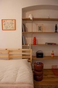 a bedroom with a bed and some shelves at Cosy Studio on Wagner street, Riga Old Town in Rīga +16 photos