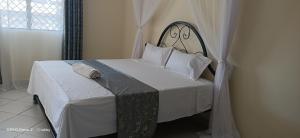 Ένα ή περισσότερα κρεβάτια σε δωμάτιο στο Malaika Gardens resort