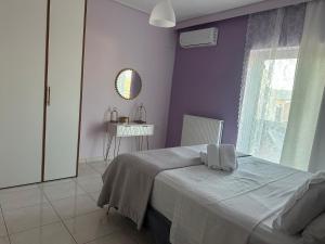 a purple bedroom with a bed and a window at Casa Ansia Luxury Living 50m from the Beach in Stalos +32 photos