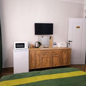 a kitchen with a counter with a microwave and a refrigerator at Armagan Suite Taksim in Istanbul