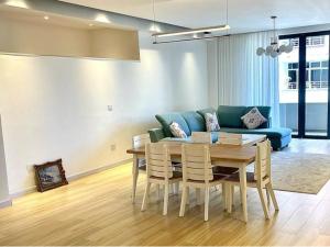 a living room with a table and a blue couch at 19&G Apt in Addis Ababa