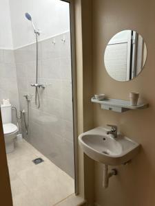 a bathroom with a shower and a sink and a mirror at Al Mohit Hôtel Dakhla in Dakhla +58 photos