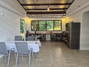 a large kitchen with a table and a refrigerator at Finca Chavela in Buenos Aires