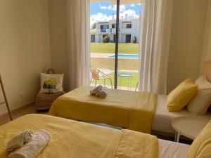 a room with two beds and a window with a view at RochAlvor in Alvor +28 photos