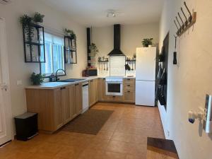 a kitchen with a white refrigerator and a tile floor at Agrotur Fenix in Telde