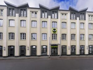 a large building with a sign on the front of it at B&B HOTEL Gera in Gera