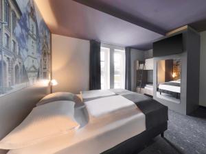 Ένα ή περισσότερα κρεβάτια σε δωμάτιο στο B&B HOTEL Gera +18 φωτογραφίες