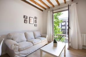a white living room with a couch and a table at Alberto Rooms habitaciones en piso compartido baño y zonas comunes compartido in Bilbao