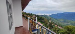 a balcony with a view of a mountain at The River View Crescent in Kurseong