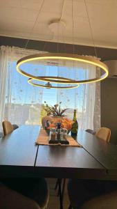 a dining room table with a large chandelier and a tableablish at KB Villa - Panoramic view in Sørvågen