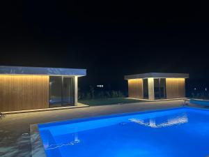 a swimming pool in front of a building at night at Elysium3 in Banja Luka +4 photos
