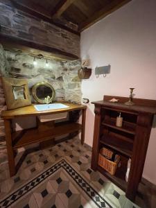 a bathroom with a sink and a mirror and a table at La Brisa Del Bierzo in Toral de Merayo +42 photos