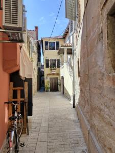a bike parked on a street in an alley at Old Town Charmer in Poreč