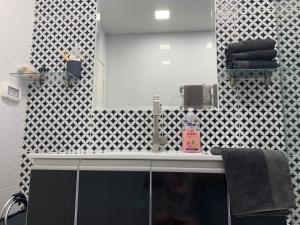a bathroom with a sink and a mirror at shahen's apartment in Ma'alot Tarshiha +13 photos