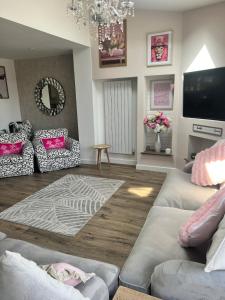 a living room with two couches and a television at Stay Solihull Large spacious home in Solihull close to NEC HS2 Bham Airport in Solihull