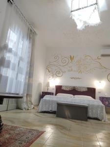 a bedroom with a bed and a chandelier at Suite Capurso Bari jacuzzi e parking in Capurso
