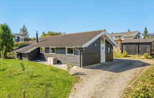a house with a garage in a yard at Beautiful Home In Rude With Kitchen in Rude +14 photos