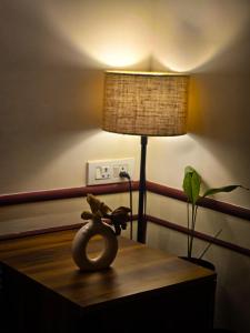 a table with a lamp and a stuffed animal on it at Zenen- Cozy 2BHK in Coimbatore +6 photos