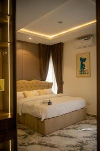 a bedroom with a large bed and a window at Two Bedroom Luxe Apt Awka in Awka