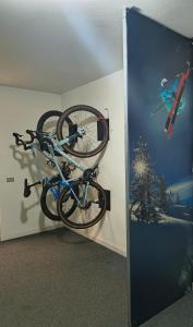 a bike hanging on a wall in a room at Hotel Sorriso in Ponte di Legno