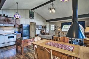 a kitchen and dining room with a wooden table at Modern Rustic Cabin - Cozy Forest Escape in Gatlinburg
