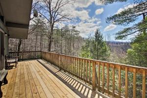 a wooden deck with a view of the mountains at Modern Rustic Cabin - Cozy Forest Escape in Gatlinburg