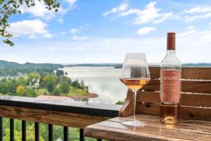 a bottle of wine and a glass on a table at Skys the Limit - Pool - Theater - Views in Sevierville