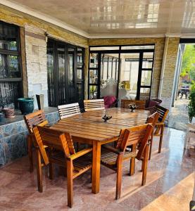 a wooden table and chairs on a patio at Nalana Guest House in Thaba Nchu