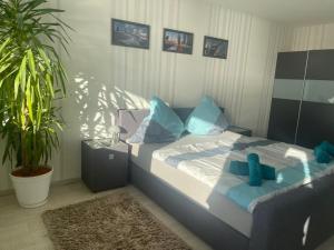 a bedroom with a bed with blue pillows at Ferienwohnung Wolke 7 in Bremerhaven +8 photos