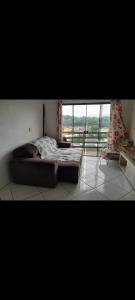 a bedroom with a bed and a large window at Casa Bela Vista in Blumenau