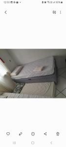 a bed sitting on a shelf in a room at Casa Bela Vista in Blumenau +2 photos