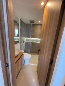 a bathroom with a toilet and a sink and a shower at Apartamento Sur de Cali in Cali